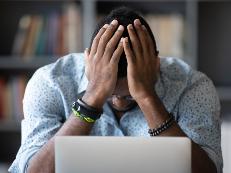 Frustrated person with hands on head, illustrating the impact of an outdated web design on business growth, featured on Sprout Marketing and Design’s blog